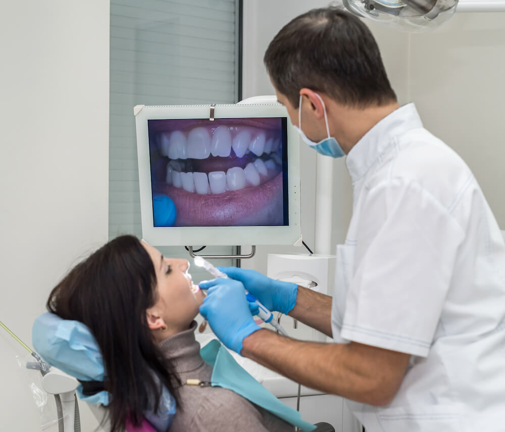 dentist using intra oral camera on patient